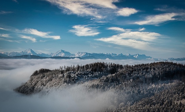 Majestic mountains covered in snow with a clear blue sky.