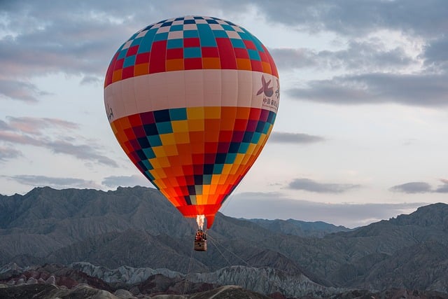 Hot air balloons floating over a scenic landscape.